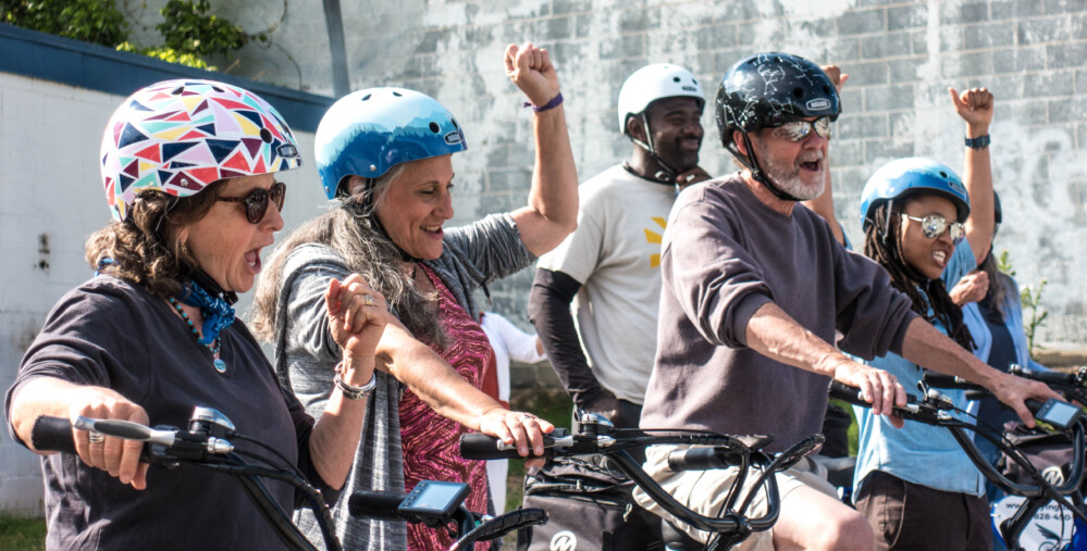 A group of cyclists are excited about their bike tour