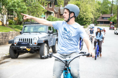 A bicycle tour guide points out the sites while riding