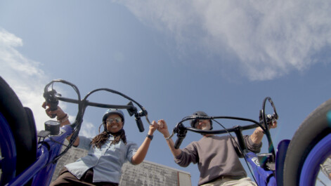 A view of two cyclists from the ground