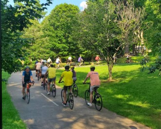 A group of cyclists ride through Inman Park in Atlanta, Georgia
