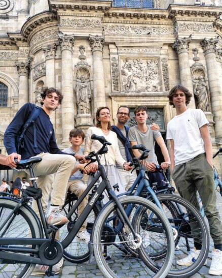 A family poses for a photo in front of the Saint Croix Church in Bordeaux, France