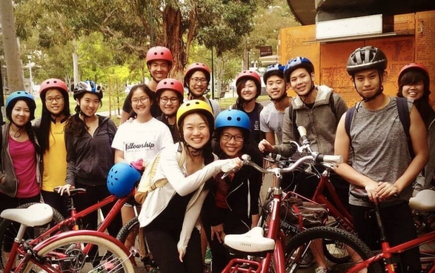 A group of cyclists stop to take a picture in Melbourne, Australia