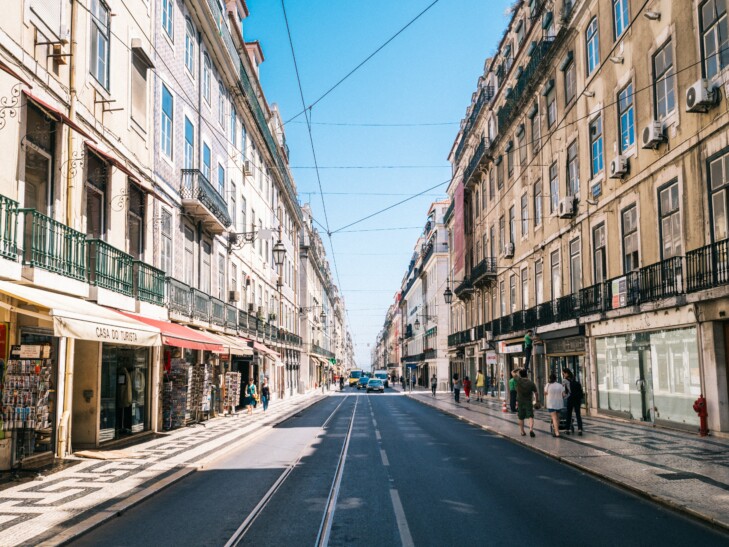 A street with cable car cables above it in Lisbon, Portugal