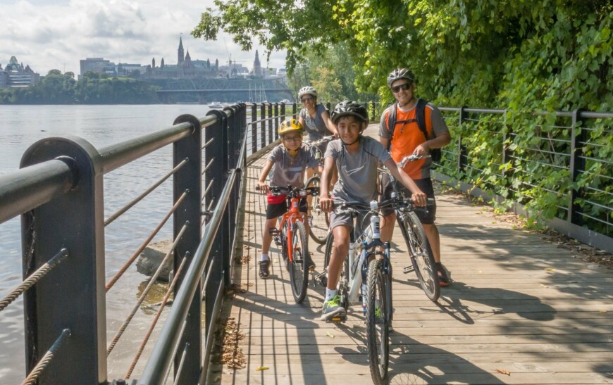 A family rides along the river in Ottawa, Canada