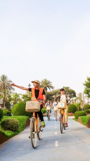 A group of cyclists ride down a bike path in Agadir