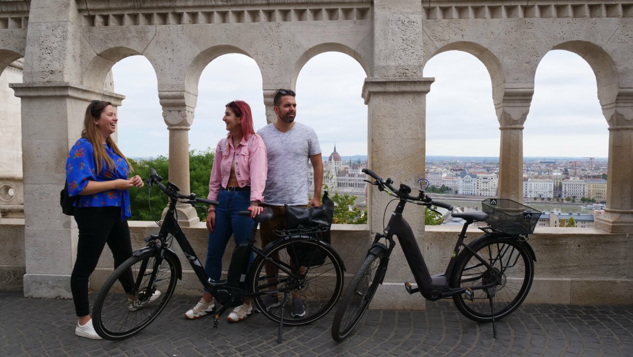 A group of cyclists stand on the Fisherman's Bastion
