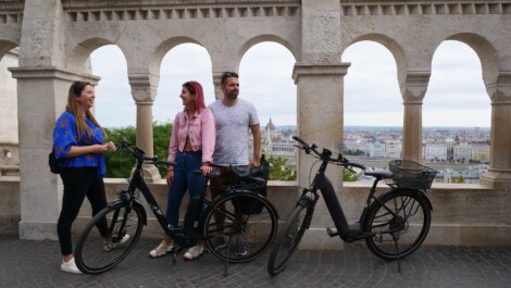 A group of cyclists stand on the Fisherman's Bastion