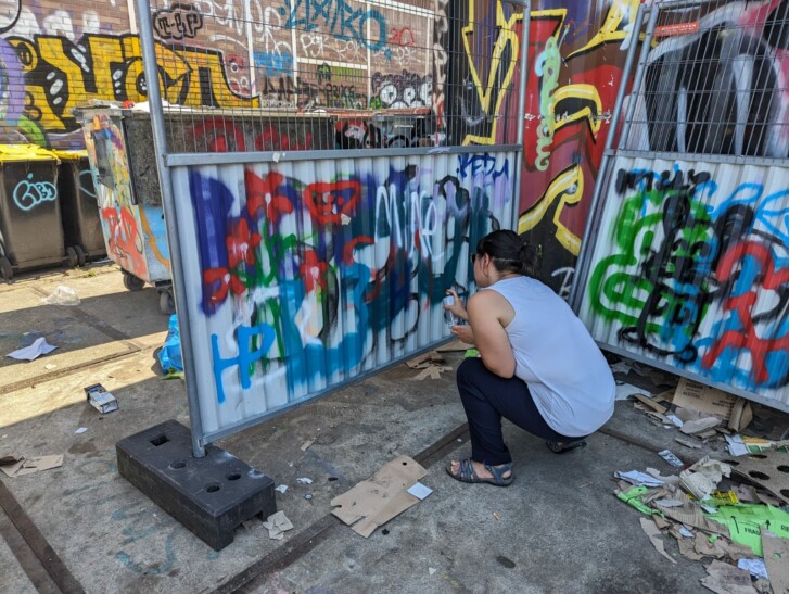 A man spray paints a temporary divider in Amsterdam